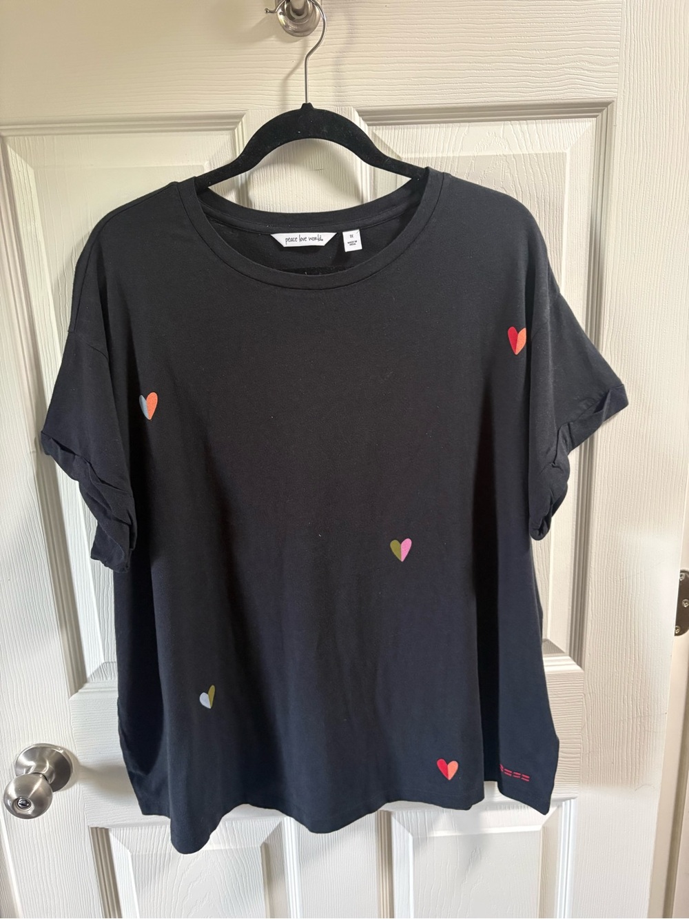 Peace Love World Black Tee with Small Multicolor Heart Accents
